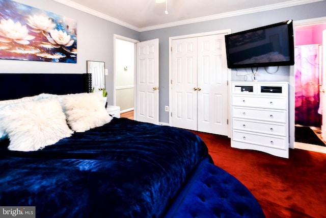 bedroom with ornamental molding, dark carpet, and a closet