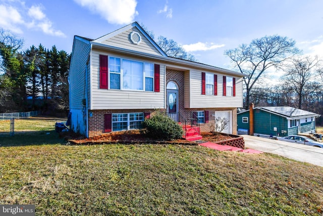 bi-level home featuring a garage and a front yard