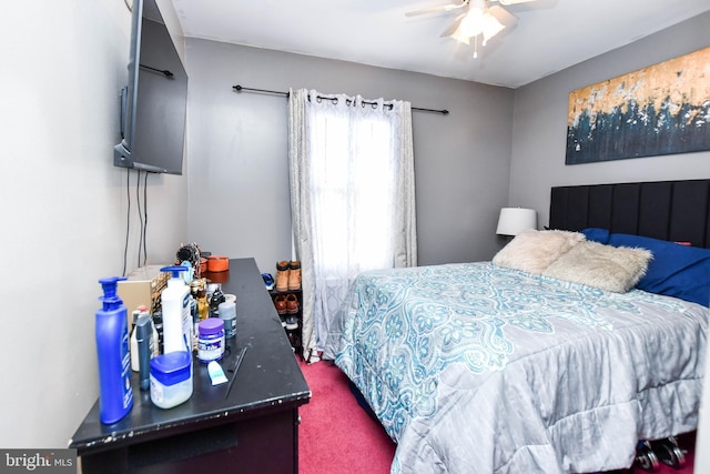 bedroom featuring ceiling fan and dark carpet