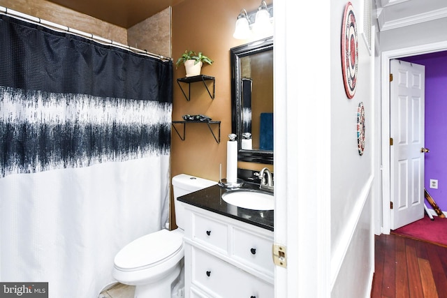 bathroom with vanity, toilet, and hardwood / wood-style floors