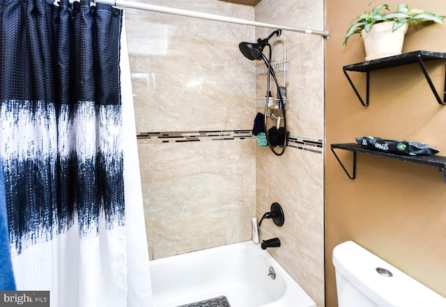 bathroom featuring shower / tub combo and toilet