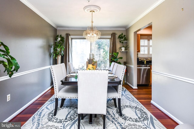 dining space featuring dark wood-type flooring, a healthy amount of sunlight, and a chandelier