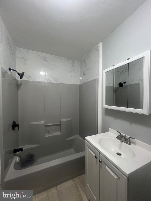 bathroom with vanity and washtub / shower combination