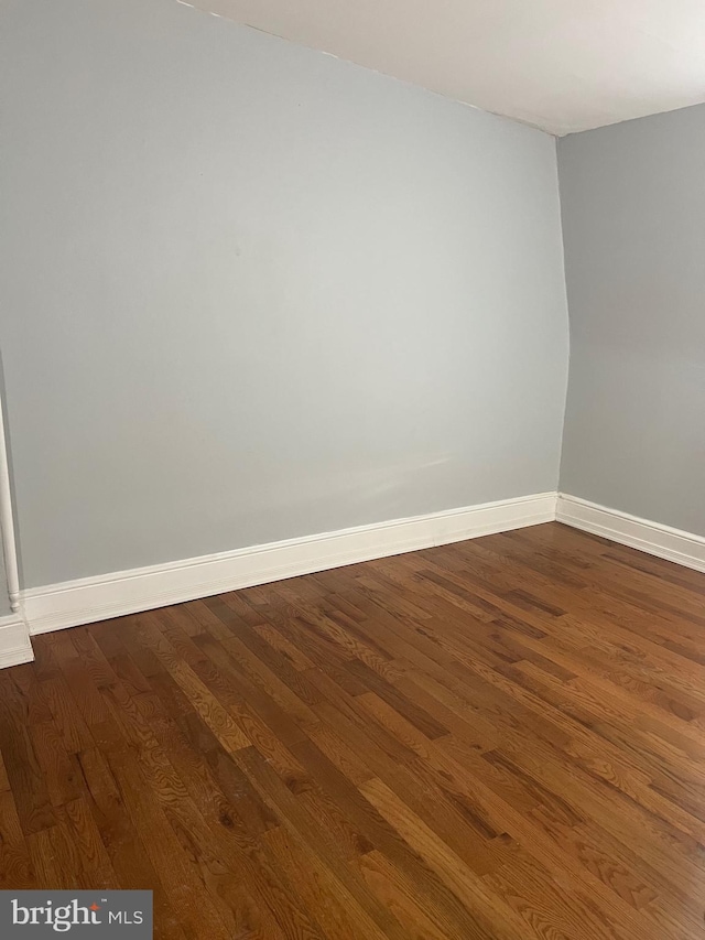 empty room with dark wood-type flooring