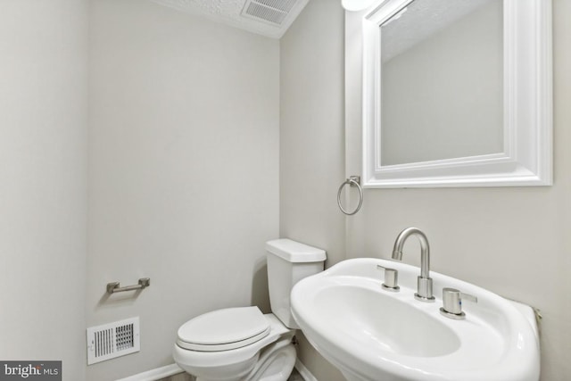 bathroom with toilet and sink