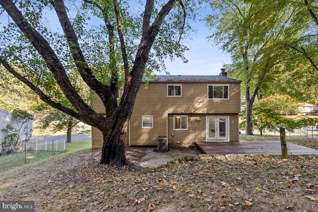 back of property with a wooden deck, french doors, and central air condition unit