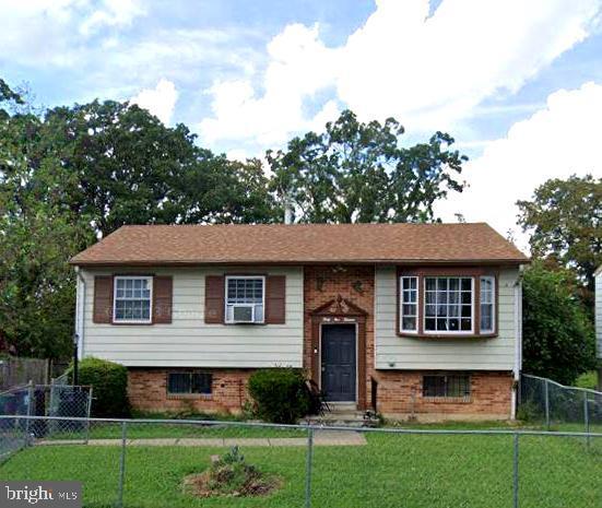 raised ranch with a front lawn