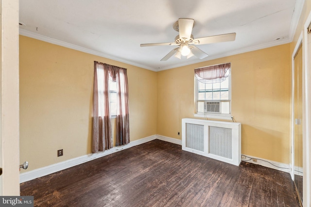 unfurnished room featuring dark hardwood / wood-style flooring, a wealth of natural light, radiator heating unit, and ornamental molding