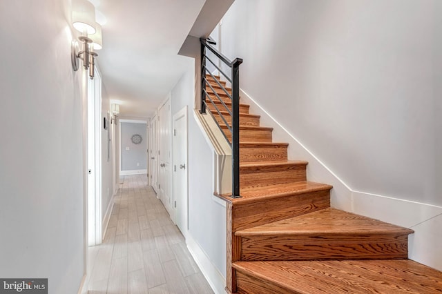 staircase featuring hardwood / wood-style flooring