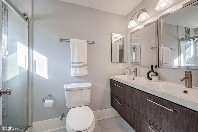 bathroom with vanity, tile patterned flooring, a shower with door, and toilet