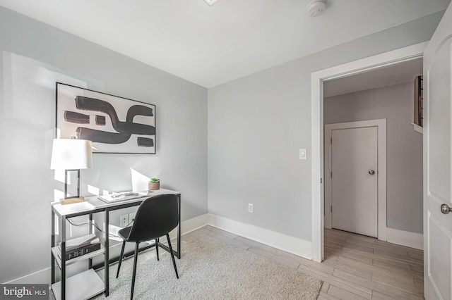 office space with light wood-type flooring