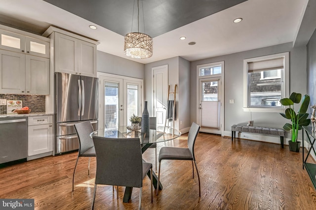 dining space featuring plenty of natural light, dark hardwood / wood-style floors, and french doors