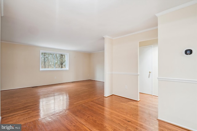 unfurnished room featuring light hardwood / wood-style flooring and ornamental molding