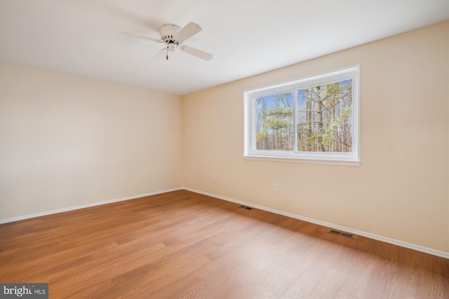 spare room with light hardwood / wood-style flooring and ceiling fan