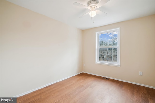 spare room featuring ceiling fan and light wood-type flooring