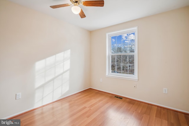 spare room with light hardwood / wood-style floors and ceiling fan