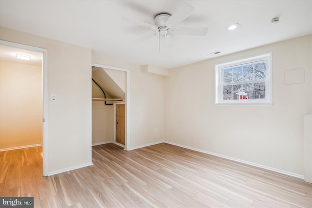 unfurnished bedroom with light hardwood / wood-style floors, a closet, and ceiling fan