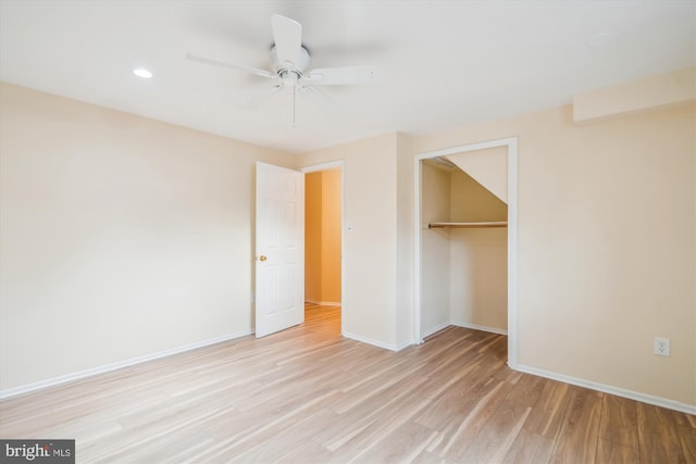 unfurnished bedroom with light hardwood / wood-style floors, a closet, and ceiling fan