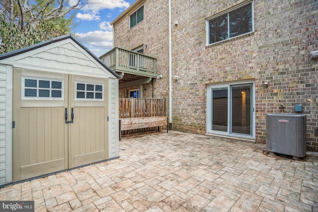 view of patio / terrace with a shed and central air condition unit