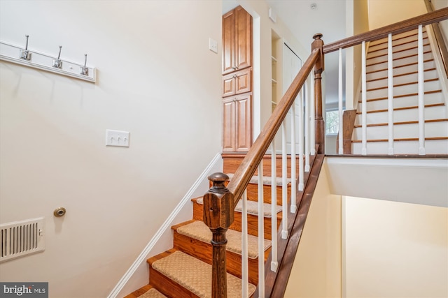 stairway with hardwood / wood-style flooring