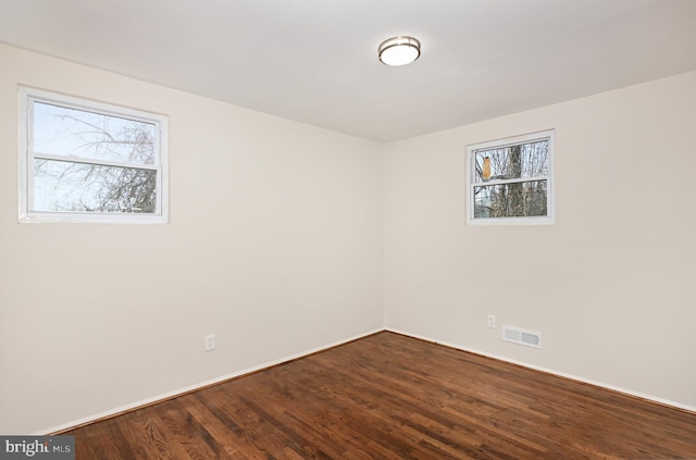 unfurnished room with hardwood / wood-style flooring