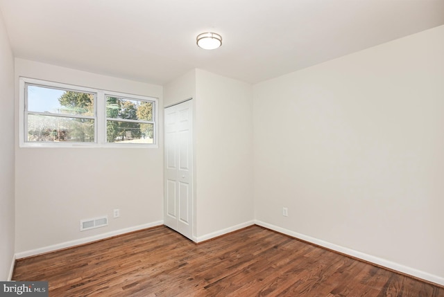 unfurnished room featuring hardwood / wood-style flooring