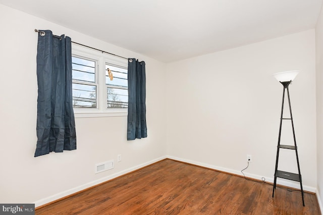 unfurnished room with dark hardwood / wood-style floors