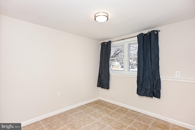 spare room featuring light tile patterned floors