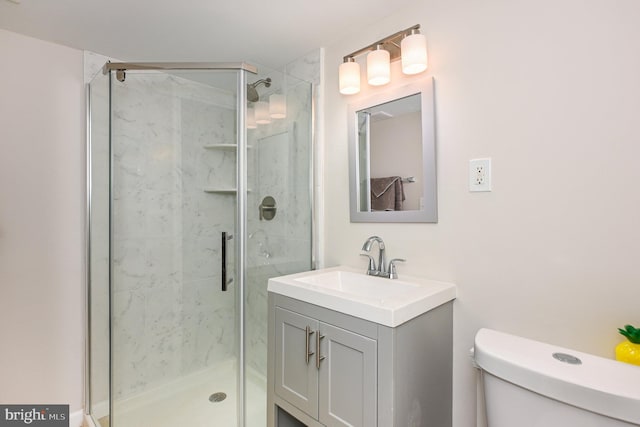 bathroom with vanity, toilet, and walk in shower