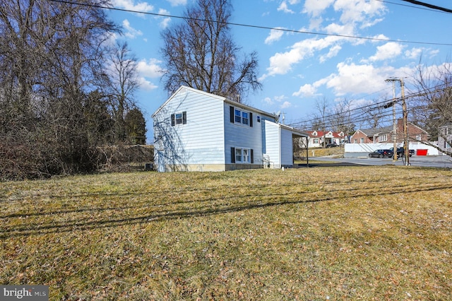 view of side of home featuring a yard