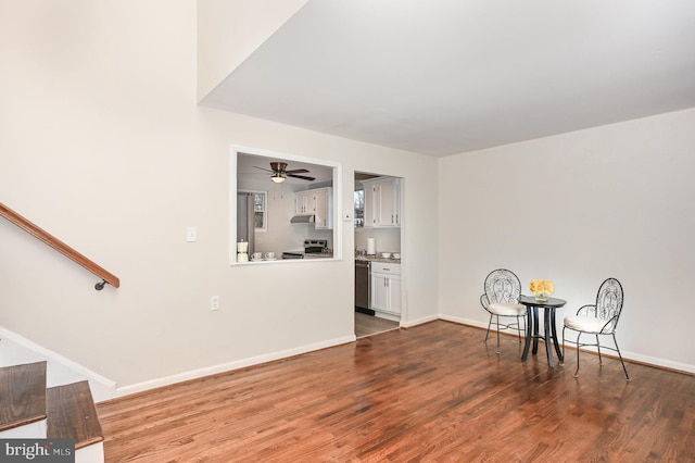 interior space with dark hardwood / wood-style flooring and ceiling fan