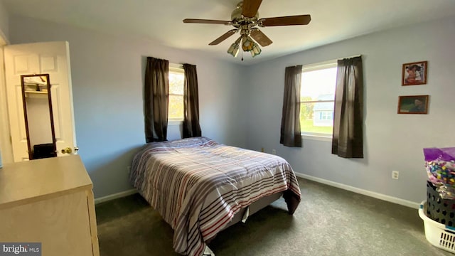 carpeted bedroom featuring ceiling fan and multiple windows