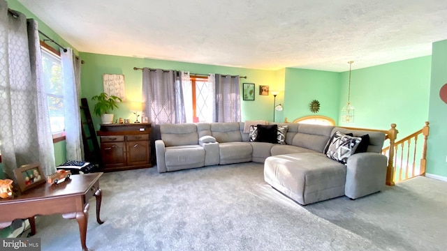 living room with light carpet and a textured ceiling