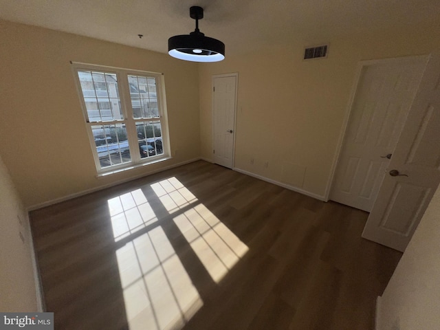 unfurnished dining area featuring dark hardwood / wood-style flooring