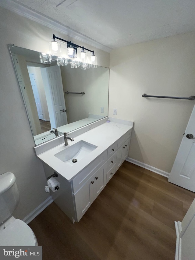 bathroom featuring vanity, hardwood / wood-style flooring, and toilet