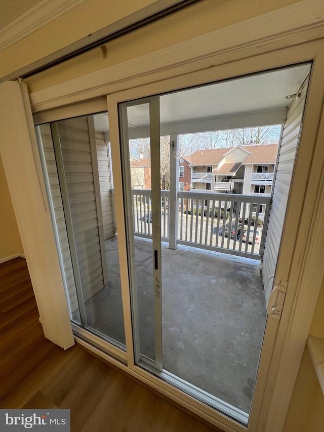 doorway to outside with wood-type flooring