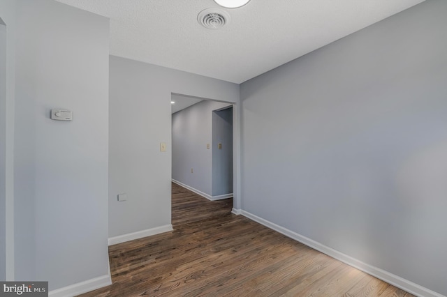 spare room featuring dark hardwood / wood-style flooring