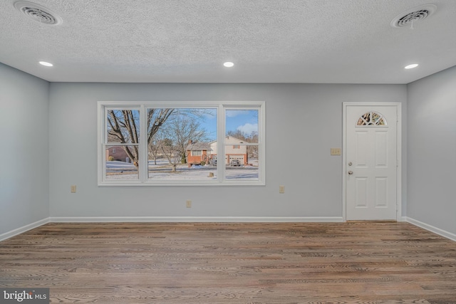 entryway featuring light hardwood / wood-style floors and a textured ceiling