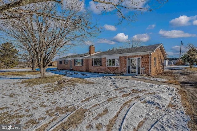 view of snow covered rear of property