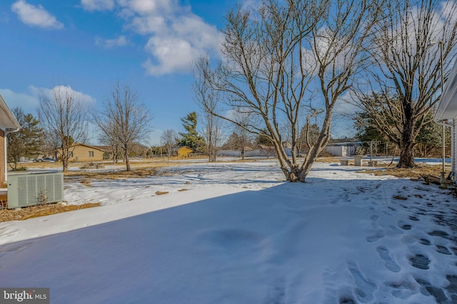 yard layered in snow with central AC unit