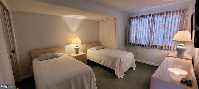 carpeted bedroom featuring a textured ceiling