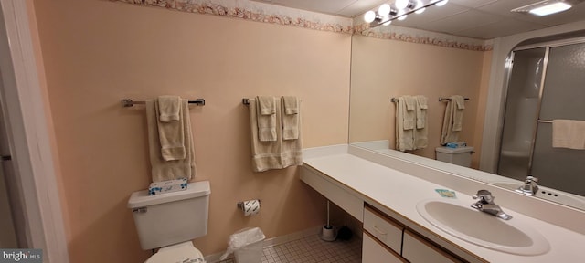 bathroom featuring vanity, toilet, tile patterned flooring, and a shower with door