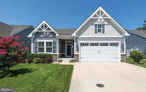 craftsman-style home featuring a garage and a front yard