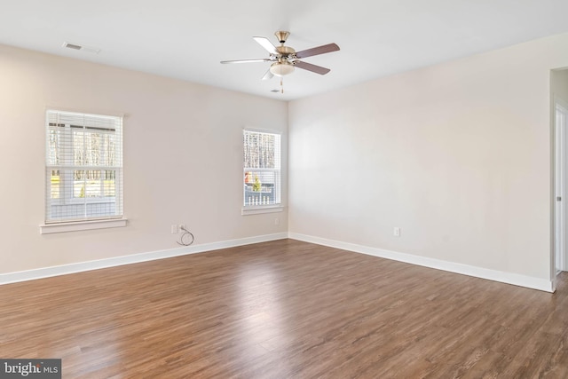 unfurnished room with dark wood-type flooring and ceiling fan