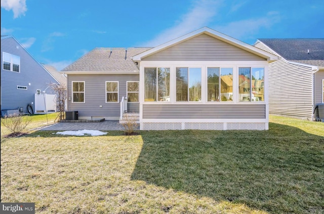 back of house with a sunroom, central air condition unit, and a lawn