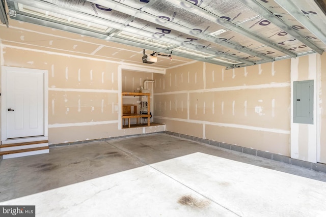 garage with a garage door opener and electric panel