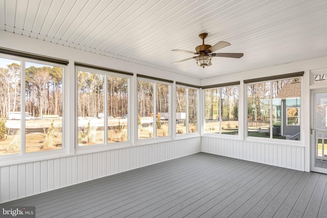 unfurnished sunroom featuring ceiling fan