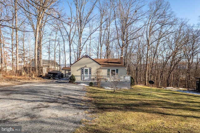 exterior space with a front yard and a deck