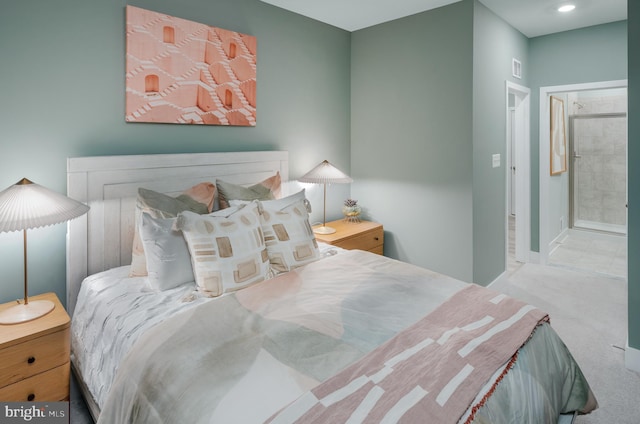 carpeted bedroom featuring ensuite bath