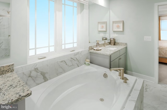 bathroom with vanity and a tub